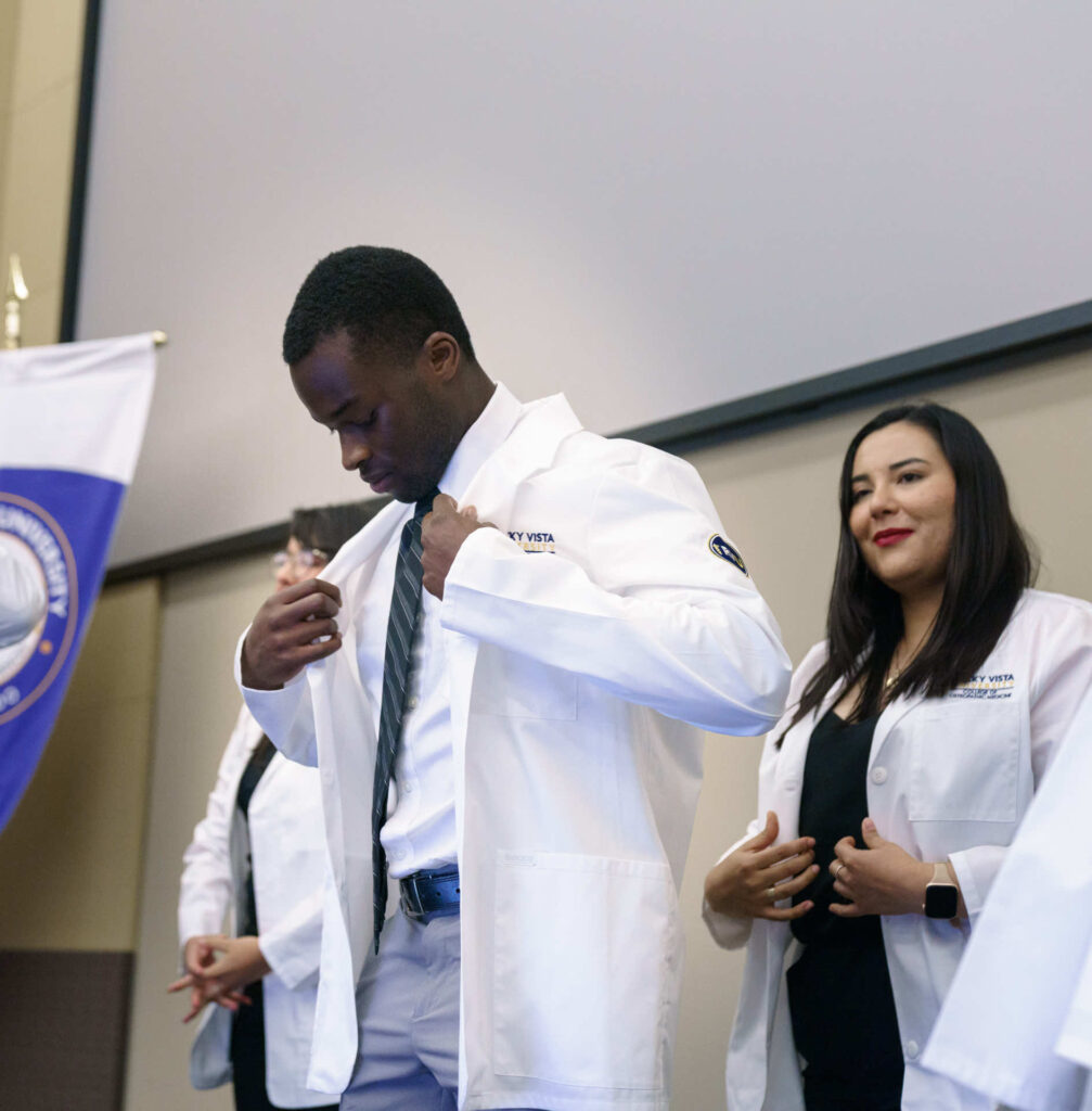 Students receiving their white, lab coats. 