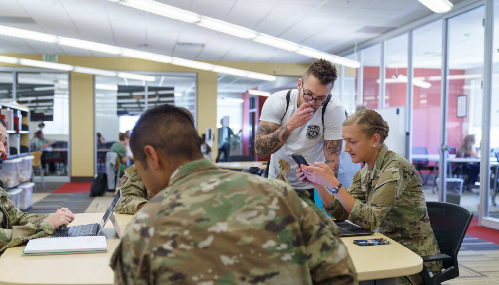 Military students working together at table. 