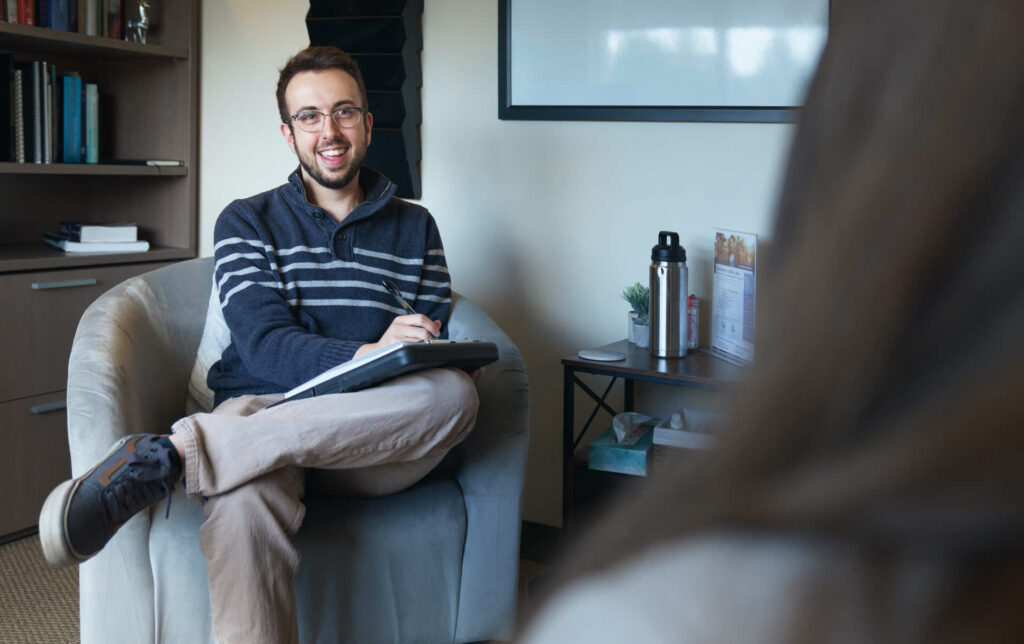 Man smiling in office on Colorado campus