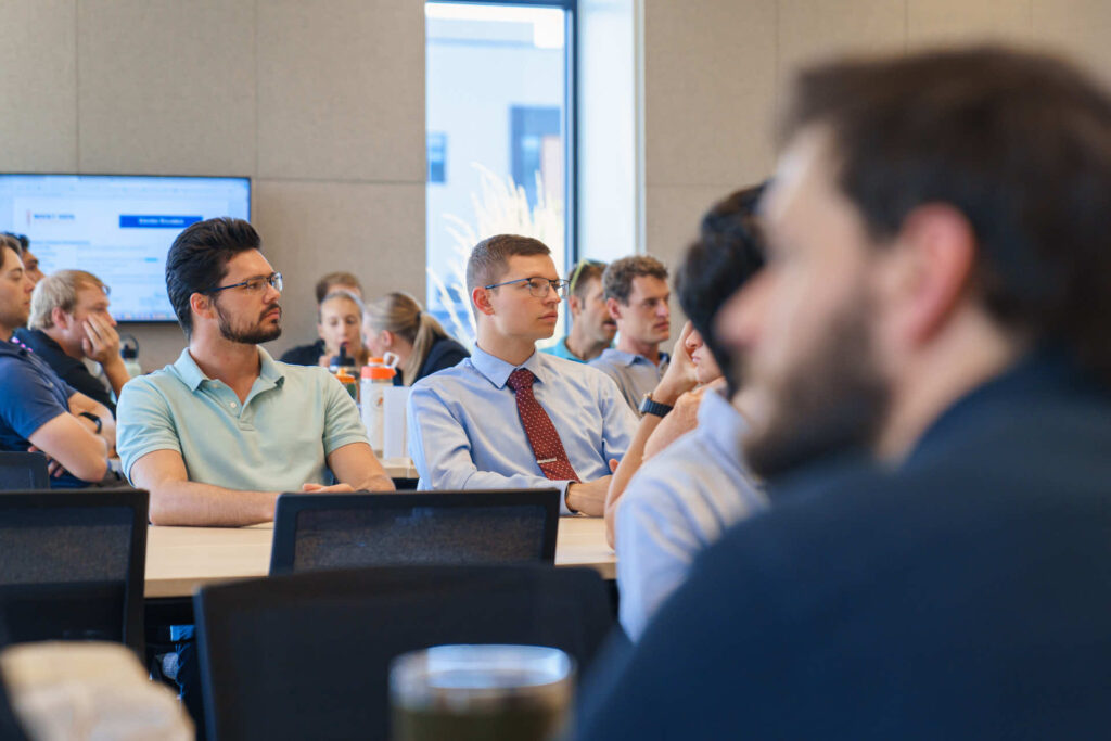 Students looking at screen in large classroom. 