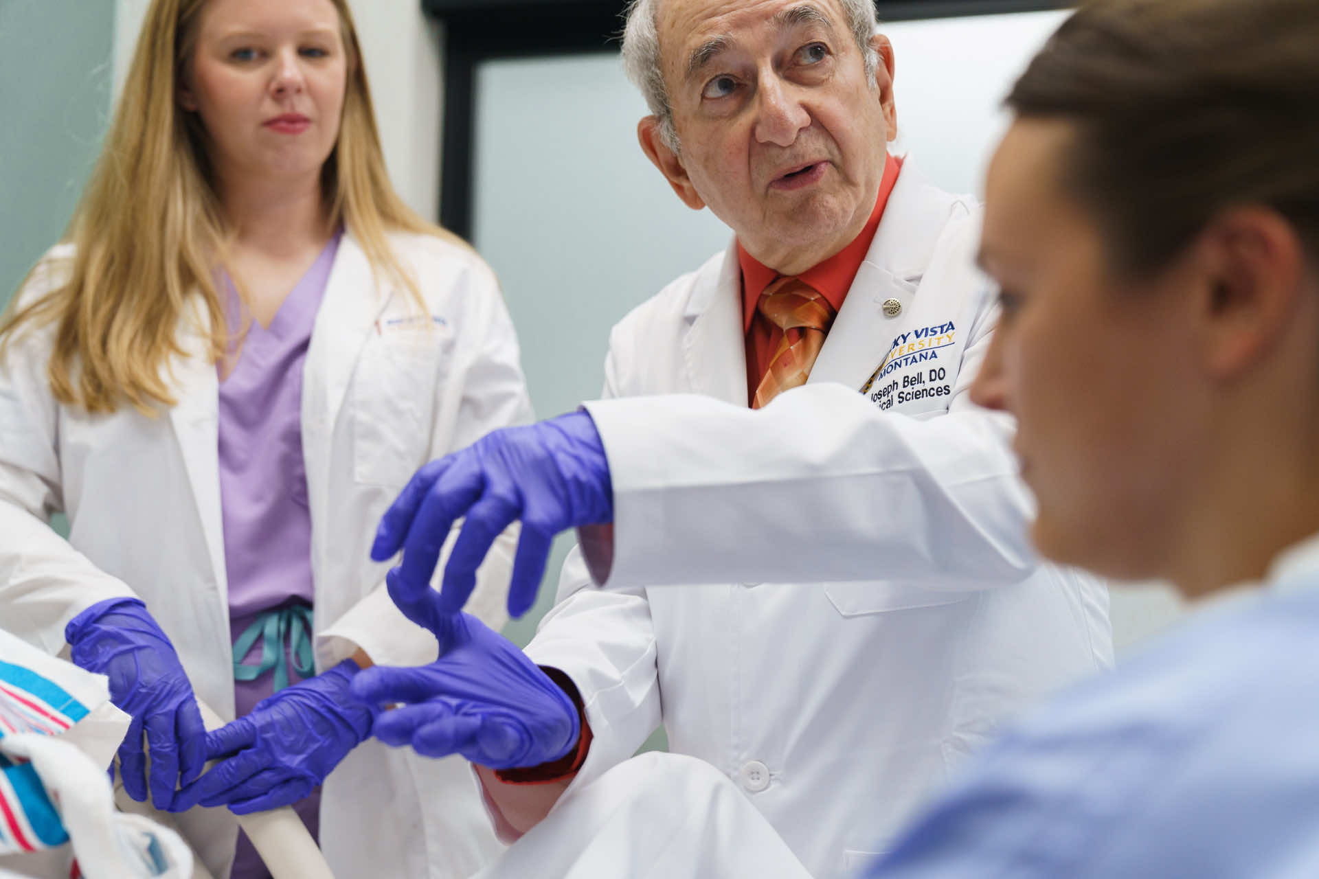 Professor talking with gloves on his hands