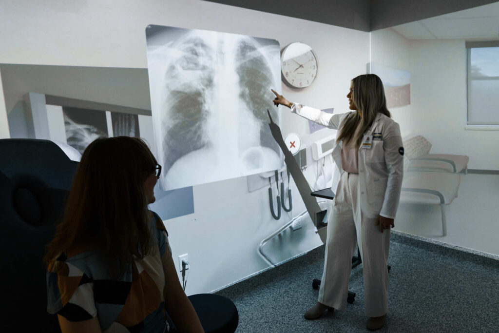 Woman pointing to a projection of an x-ray