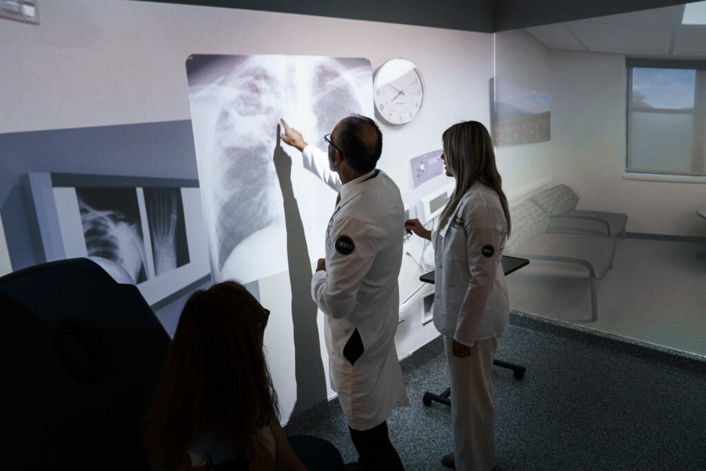 Teacher showing a med student an x-ray.