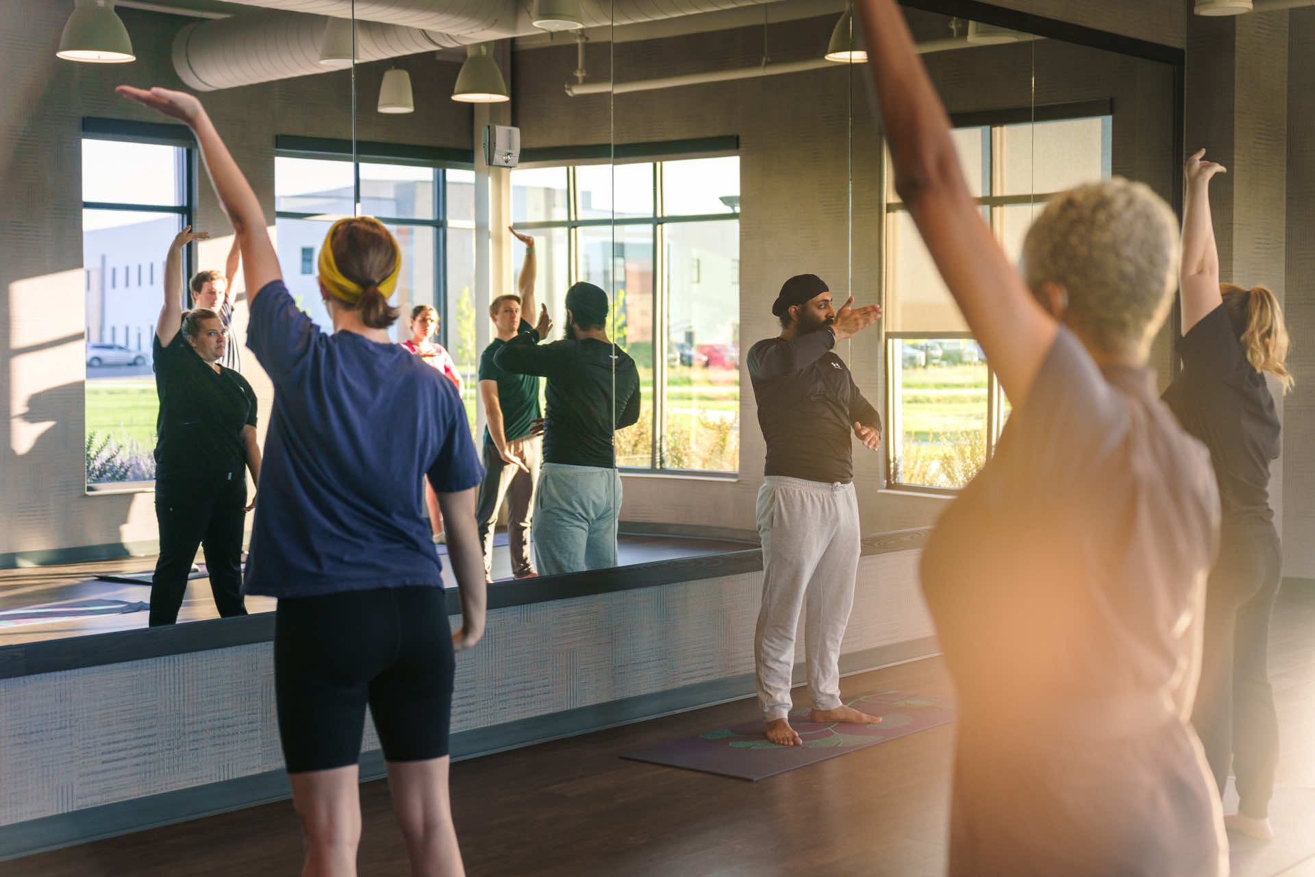 Med students doing yoga in studio.