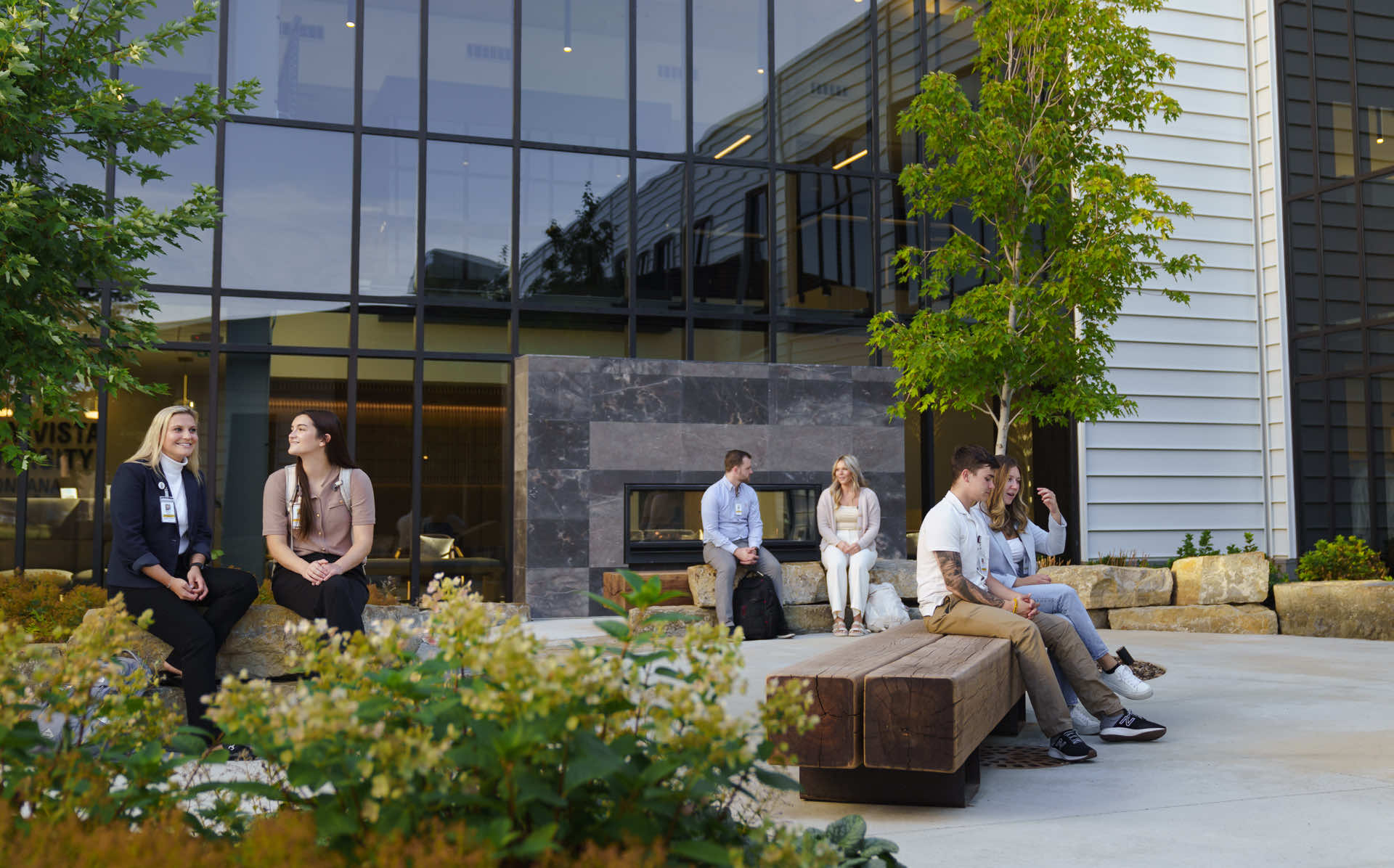 Students and staff sitting outside of Montana campus building.