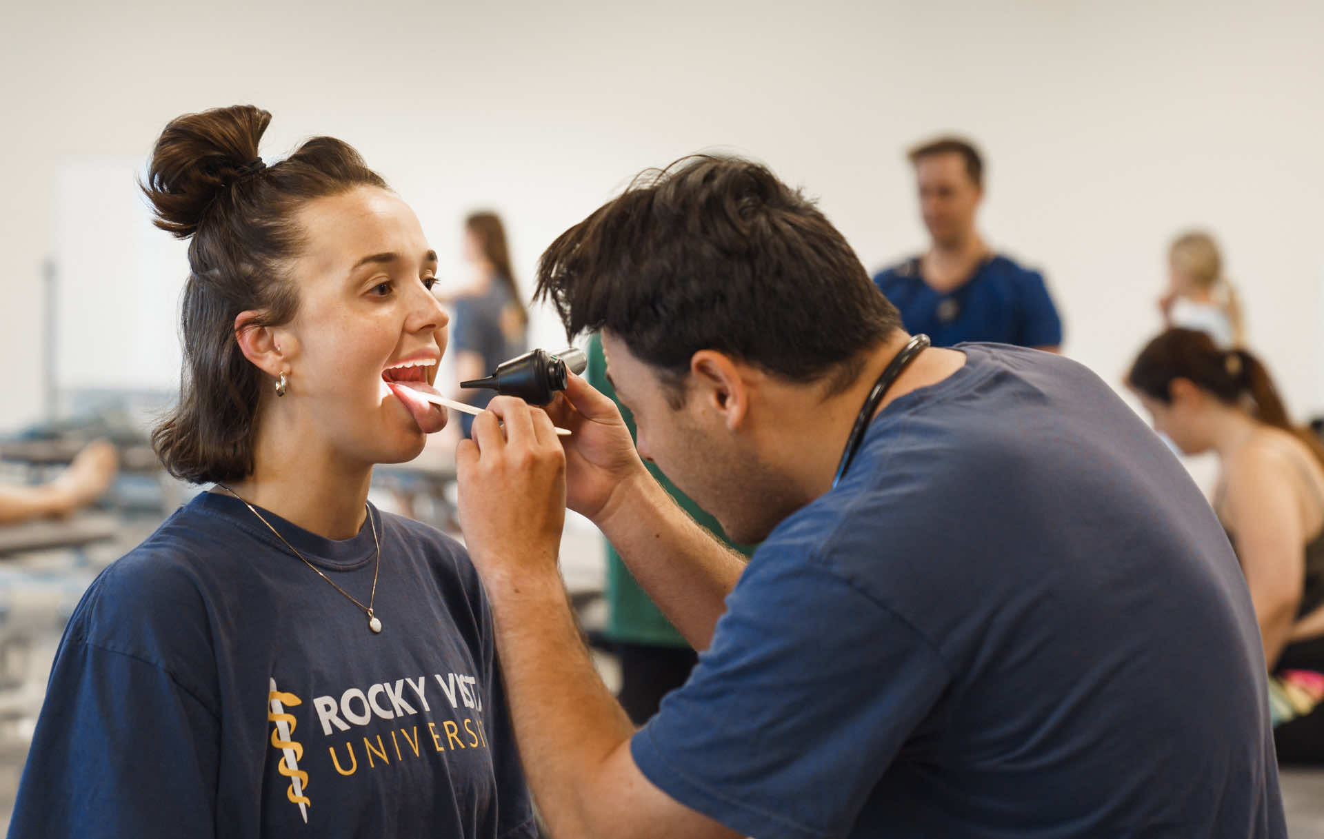 Woman getting the inside of her mouth checked.