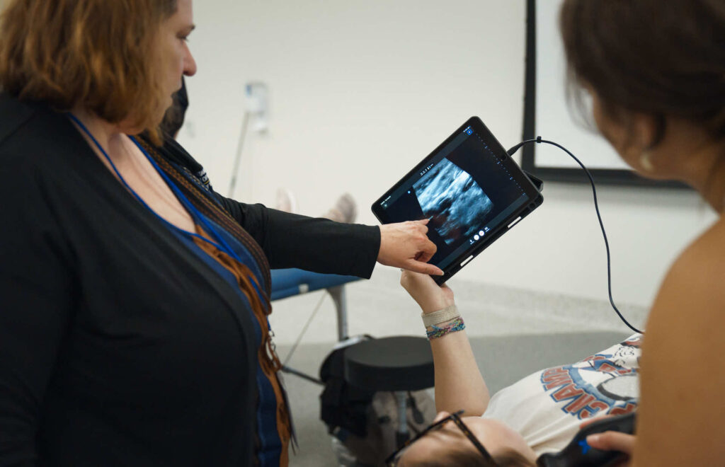 Woman looking at ultra sound with student. 