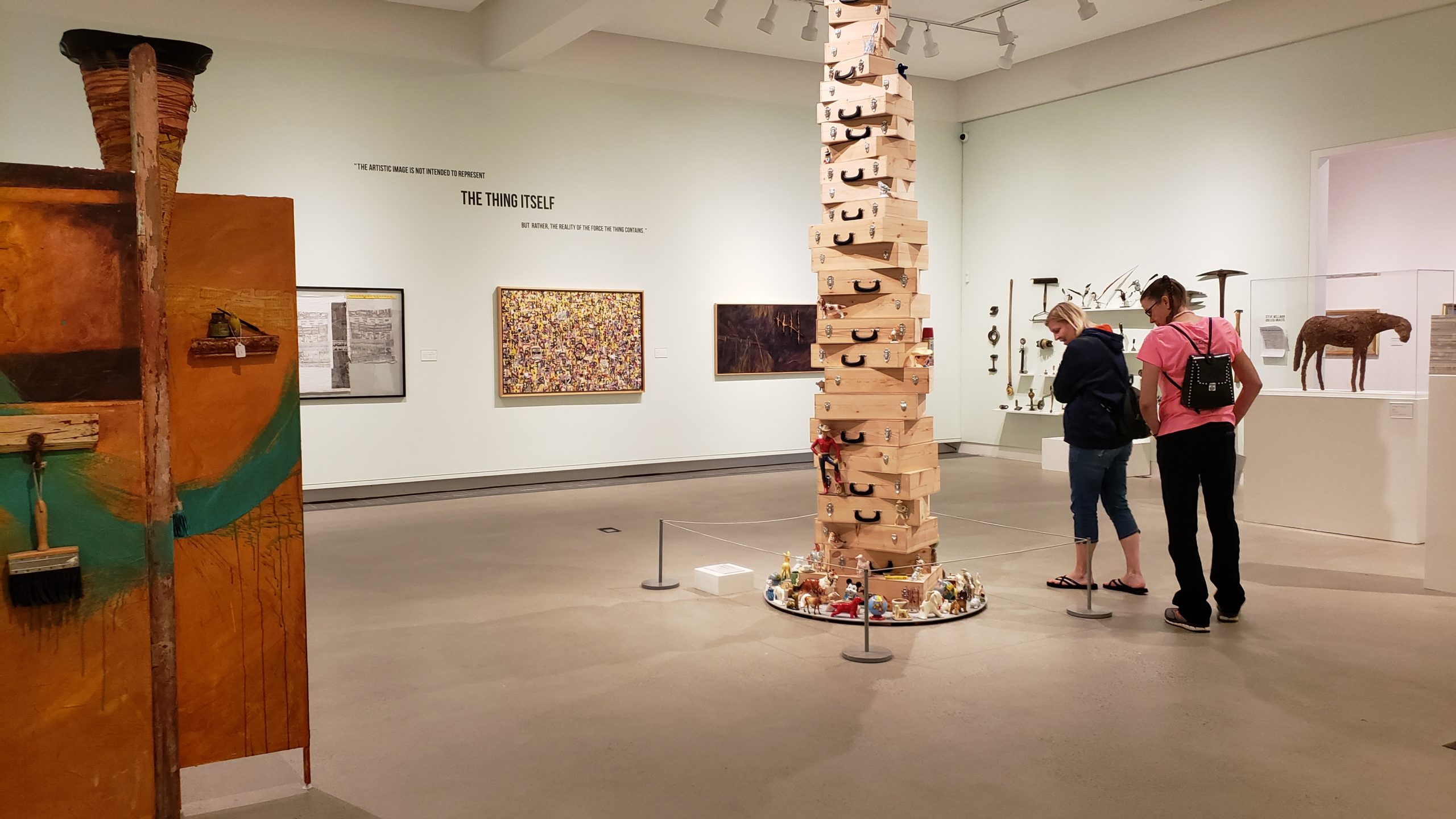 Two people walking around an art museum. 