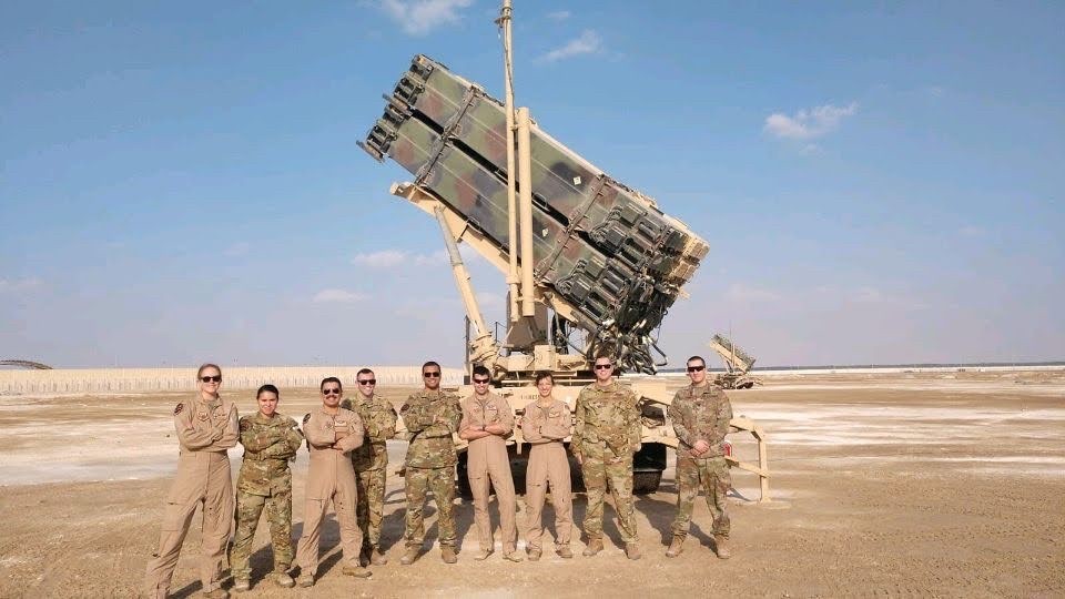 Dr. Stiegmann with 8 other soldiers in front of military equipment