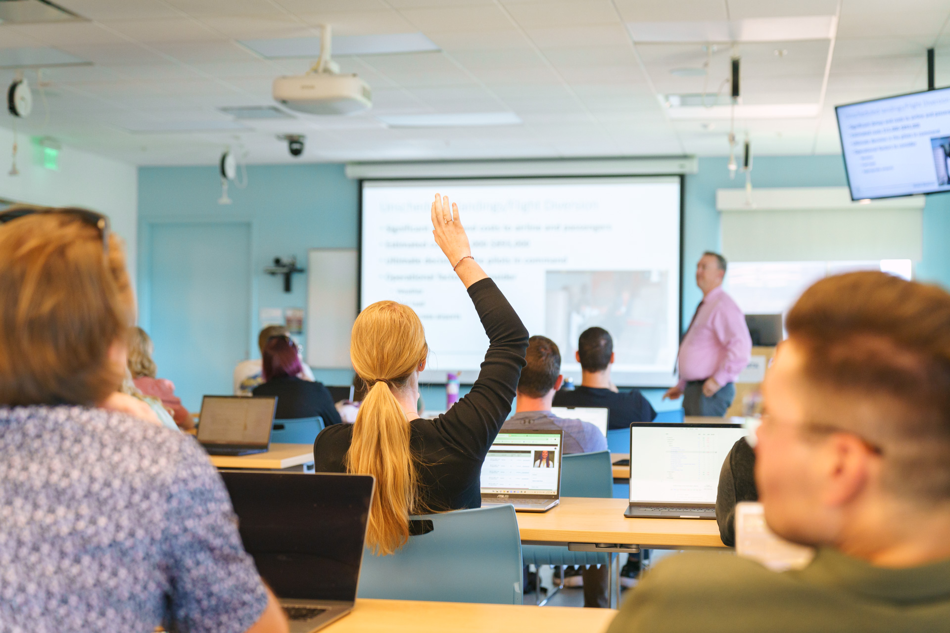 Woman raising hand in a classroom