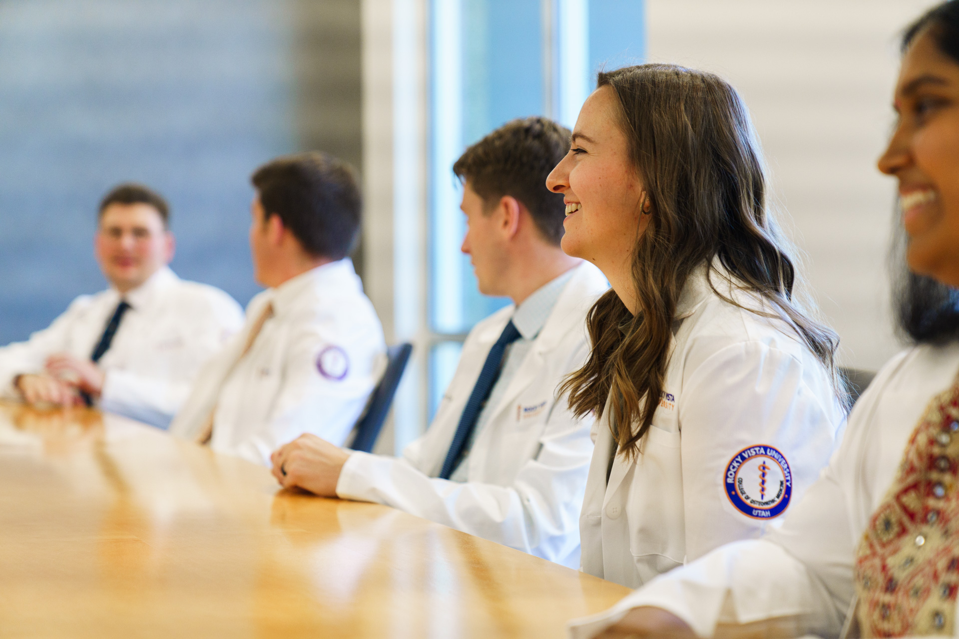 Medical students sitting at a long table