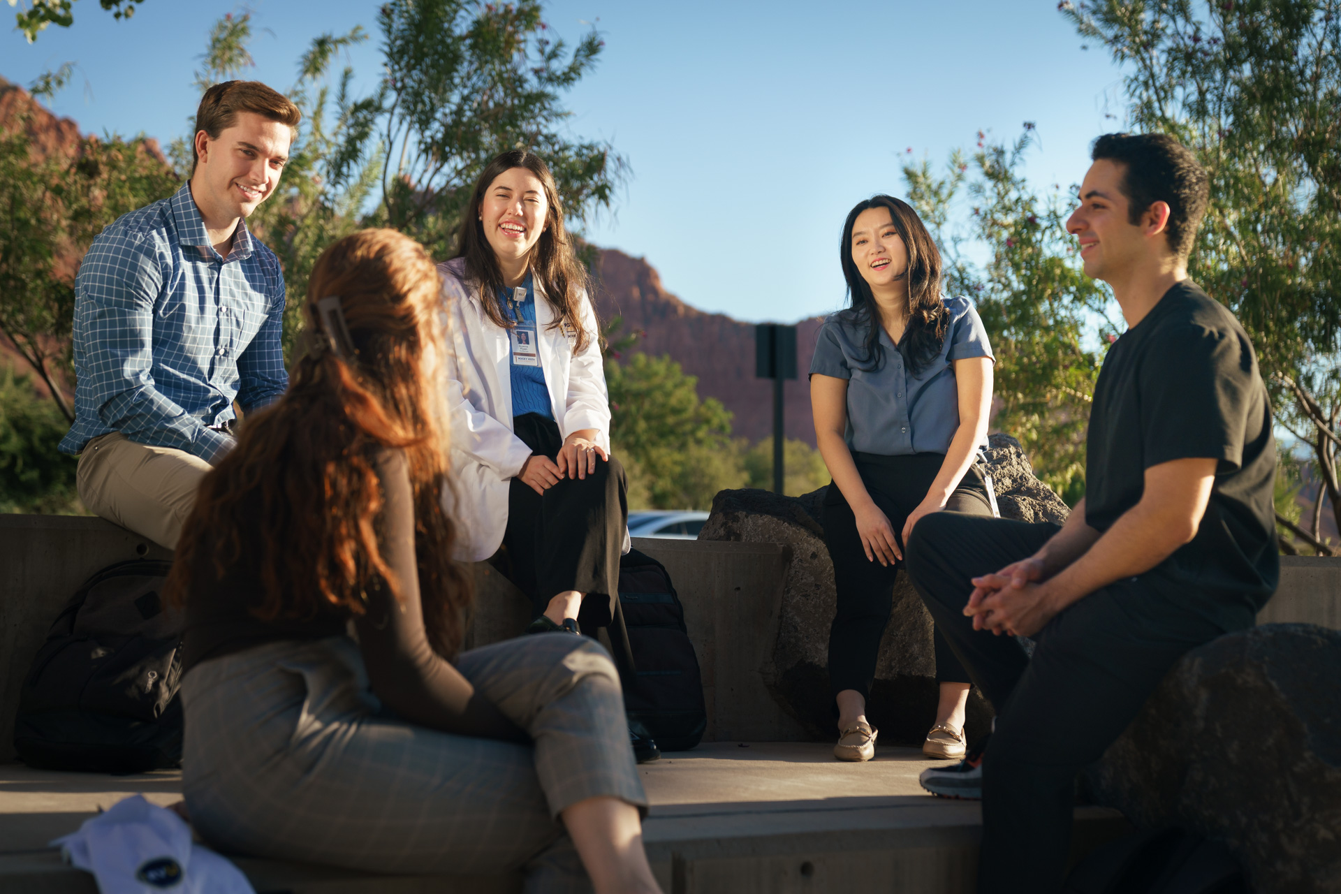 Students sitting around on seats outside of Utah Campus.