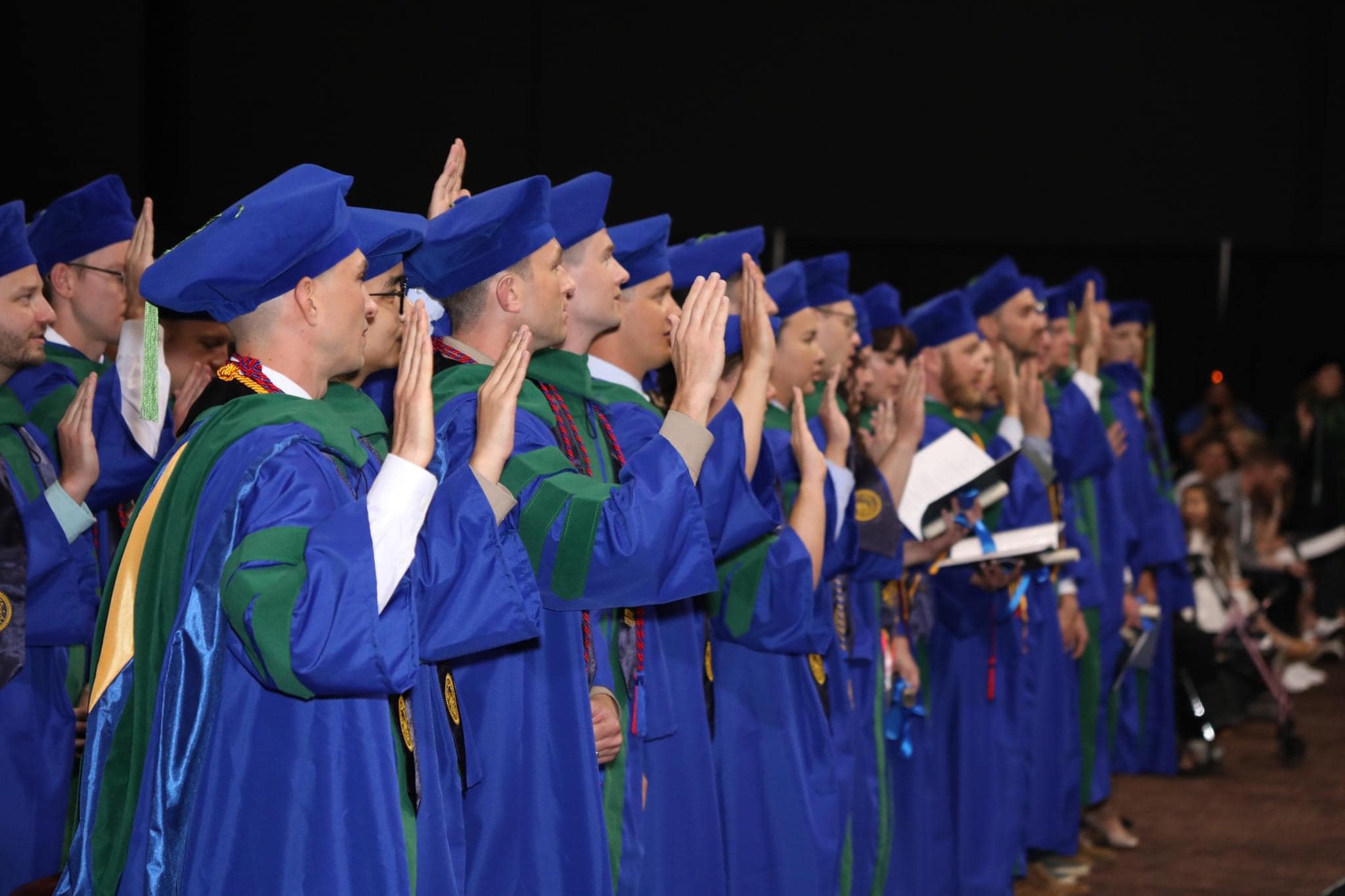 Utah COM Graduates taking their oath at commencement